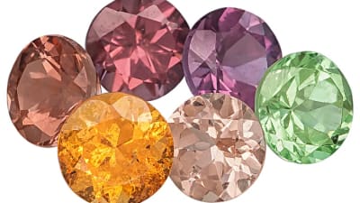 a group of faceted and different colored garnet gemstones