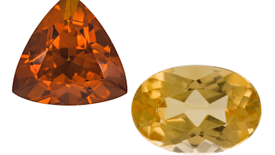 A faceted topaz gemstone is next to a faceted citrine gemstone