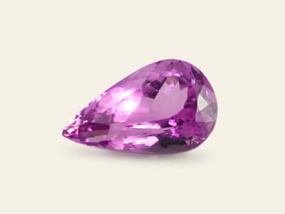 a polished and faceted pinkish-purple kunzite gemstone
