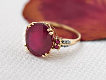 round red ruby ring set in yellow gold