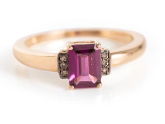 emerald cut grape garnet set in yellow gold ring