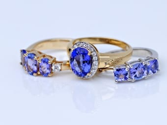 three tanzanite rings - oval shaped tanzanite ring set in yellow gold,
tri-stone tanzanite ring set in yellow gold, tri-stone tanzanite ring
set in silver