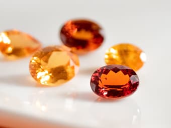 multiple oval shaped spessarite garnet gemstones