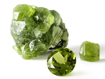 variety of peridot - single round brilliant cut peridot, large uncut
peridot specimen and small uncut peridot