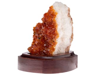 large uncut orange citrine specimen on wooden stand