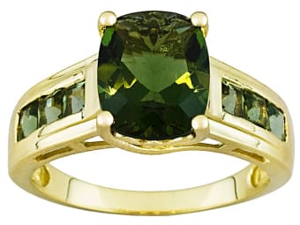 Faceted moldavite in a gold ring.