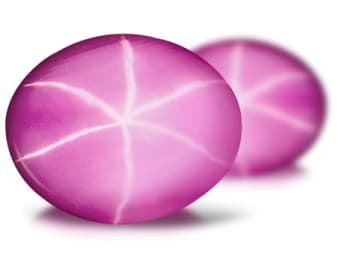 two pink oval shaped lab created flame fusion star ruby