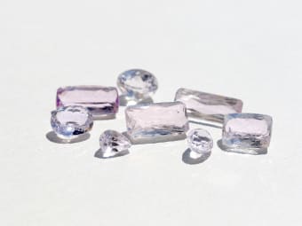 a group of colorless and pink kunzite gemstones