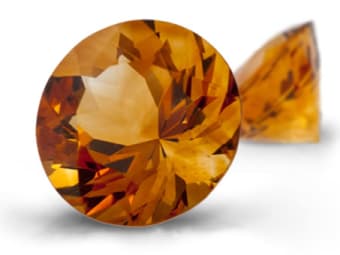 A front and side view of a round-brilliant cut citrine gemstone