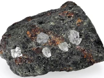 Natural diamond specimens present within kimberlite.