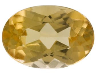 An oval cut and faceted yellow-topaz gemstone.