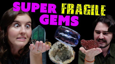 A woman and man view fragile gemstone specimens.