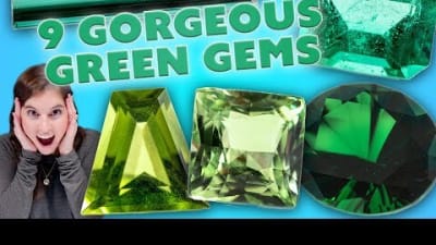 A woman is excited by gorgeous green gemstones.
