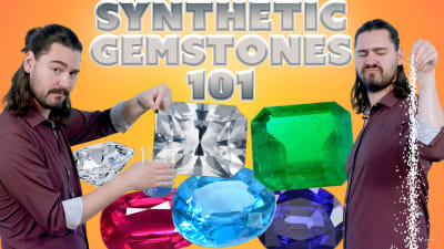 A gemologist poses with a group of polished, faceted and synthetic gemstones.