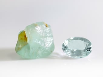 rough aquamarine specimen and oval shaped aquamarine gemstone 